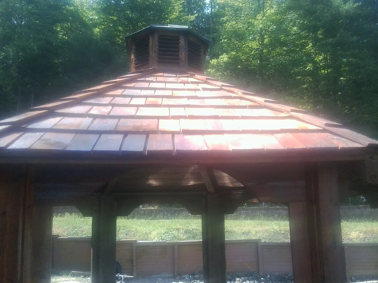 New cedar shake roof and cupola on a lakeside gazebo in Cornish